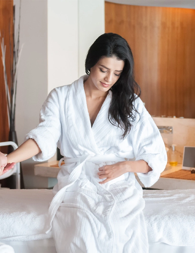 A close-up view of a person’s arm resting on a white surface during a medical treatment. A small piece of medical tape secures a clear IV tube to the inner elbow. The image is brightly lit with a clean, clinical aesthetic and a shallow depth of field. - IV therapy in Draper, UT